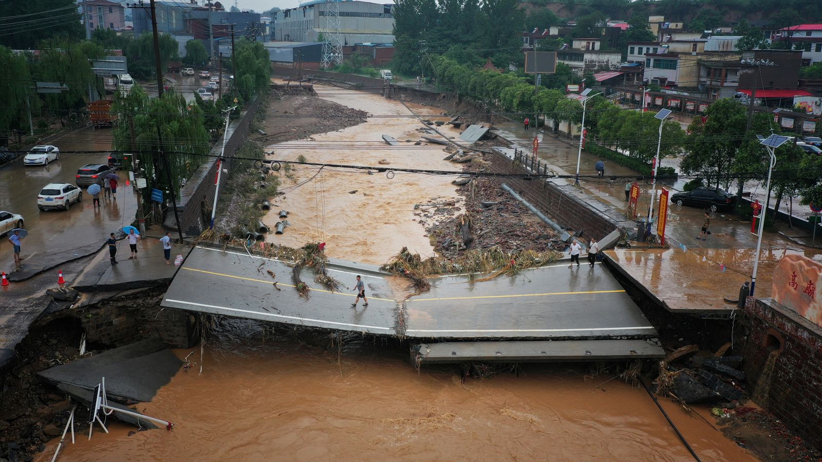 China floods force tens of thousands from their homes as number dead